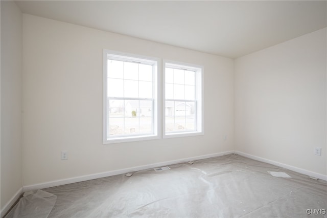 unfurnished room with baseboards and light colored carpet