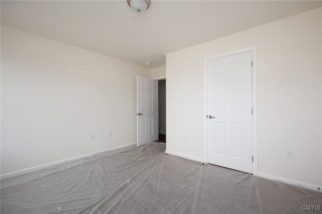 unfurnished bedroom with carpet and baseboards