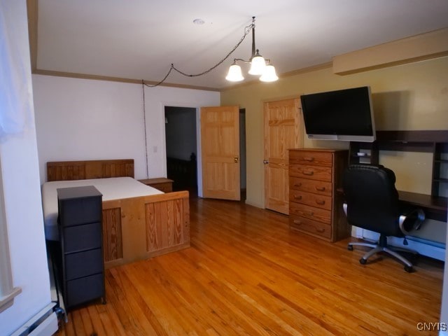36 Lincoln Ave, Cortland, NY 13045 - office area with an inviting chandelier, a baseboard heating unit, crown molding, and light wood finished floors