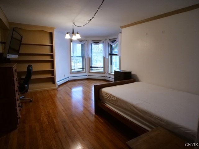 36 Lincoln Ave, Cortland, NY 13045 - bedroom with wood finished floors and an inviting chandelier