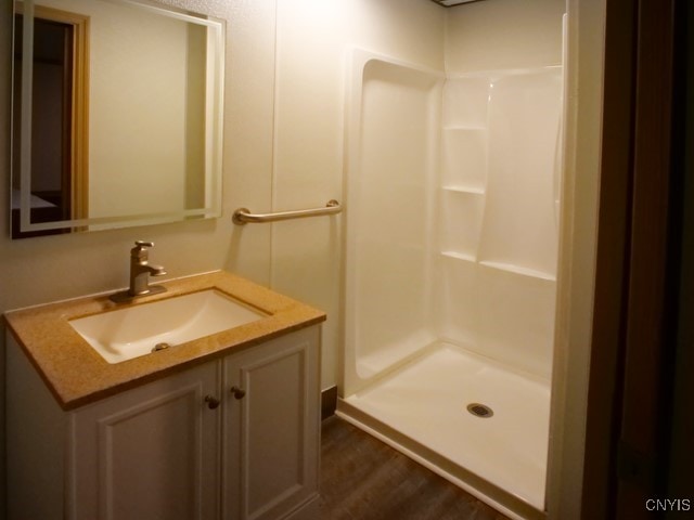 36 Lincoln Ave, Cortland, NY 13045 - full bathroom with a shower stall, wood finished floors, and vanity