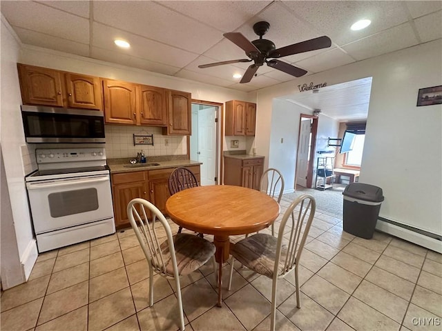 36 Lincoln Ave, Cortland, NY 13045 - kitchen with light tile patterned flooring, backsplash, a ceiling fan, white range with electric stovetop, and stainless steel microwave