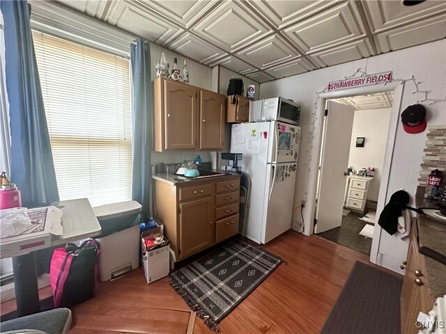 36 Lincoln Ave, Cortland, NY 13045 - kitchen with freestanding refrigerator, stainless steel microwave, an ornate ceiling, and wood finished floors