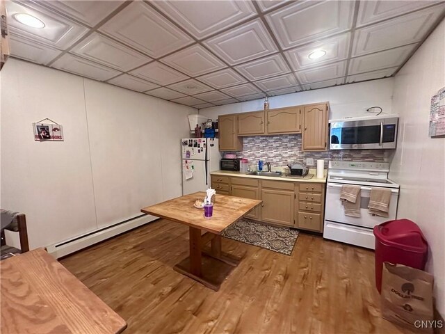 36 Lincoln Ave, Cortland, NY 13045 - kitchen featuring light countertops, white appliances, dark wood finished floors, a sink, and baseboard heating