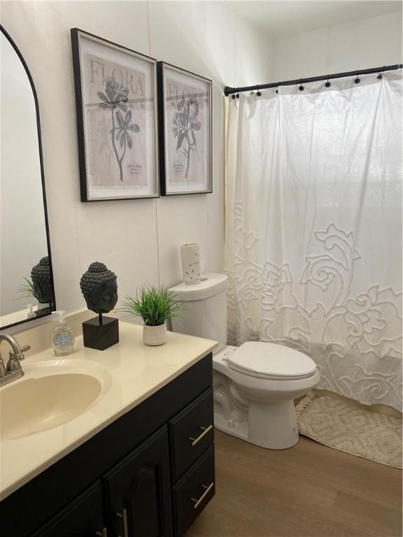 115 Aster Dr, Horseheads, NY 14845 - full bath with toilet, curtained shower, wood finished floors, and vanity