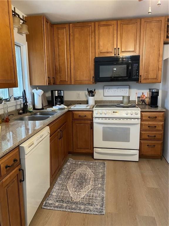 115 Aster Dr, Horseheads, NY 14845 - kitchen featuring a sink, brown cabinets, light wood finished floors, and white appliances