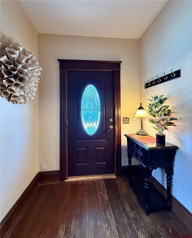 foyer entrance featuring dark wood-type flooring and baseboards