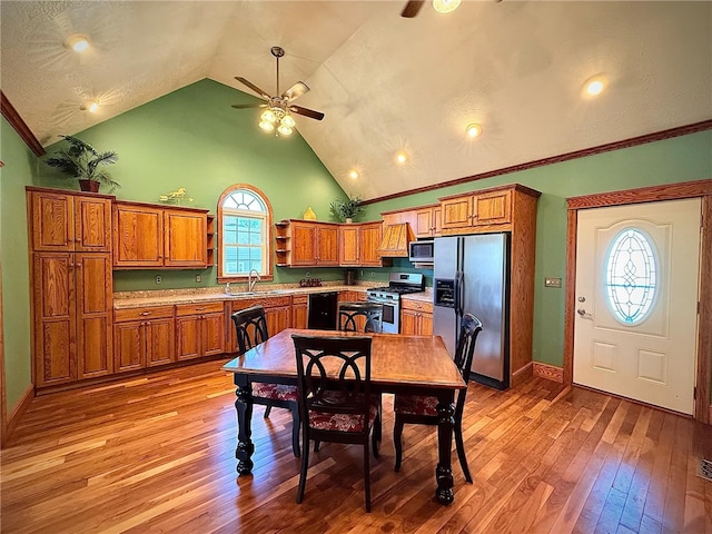 dining space with baseboards, light wood-type flooring, high vaulted ceiling, and ceiling fan