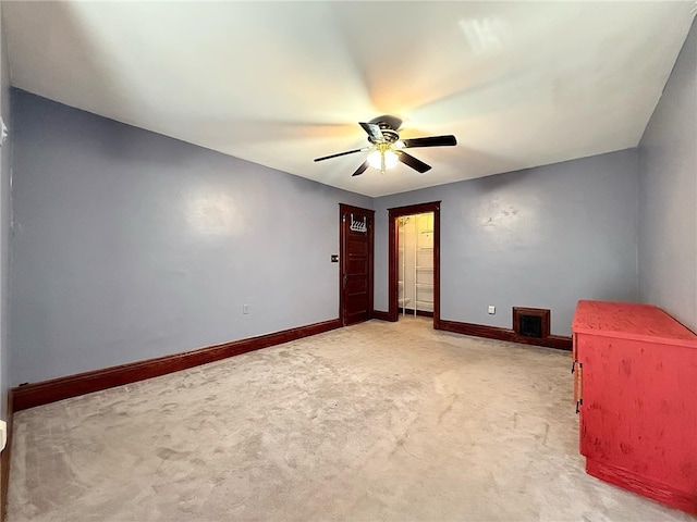 unfurnished bedroom featuring light carpet, baseboards, ceiling fan, and visible vents