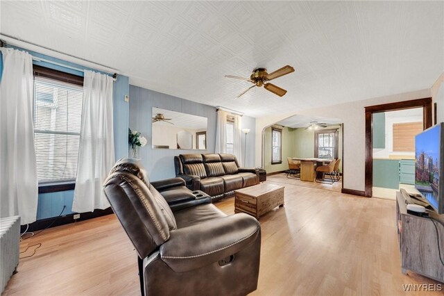 2486 Willow Ave, Niagara Falls, NY 14305 - living room with light wood finished floors, baseboards, ceiling fan, and radiator heating unit