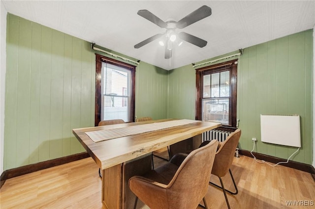 2486 Willow Ave, Niagara Falls, NY 14305 - dining area featuring baseboards, a ceiling fan, light wood-type flooring, and plenty of natural light