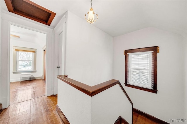 2486 Willow Ave, Niagara Falls, NY 14305 - hall featuring baseboards, an upstairs landing, vaulted ceiling, and light wood-style floors