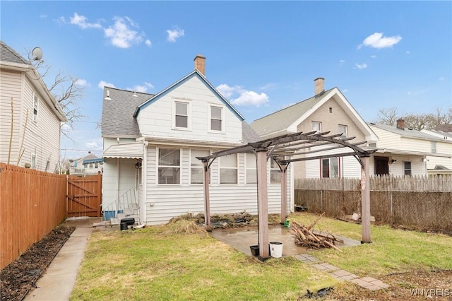 2486 Willow Ave, Niagara Falls, NY 14305 - rear view of house with a pergola, a fenced backyard, and a yard