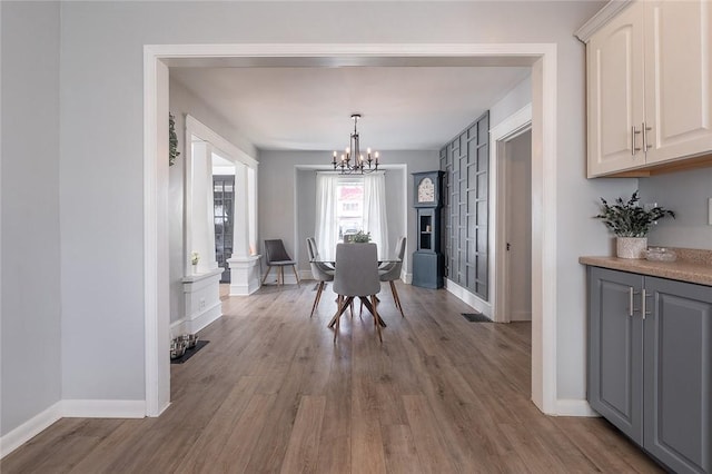 120 Westmont Ave, Elmira, NY 14905 - dining room with wood finished floors, a notable chandelier, and baseboards