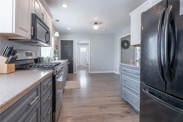 120 Westmont Ave, Elmira, NY 14905 - kitchen featuring black appliances, light countertops, light wood-style flooring, and baseboards
