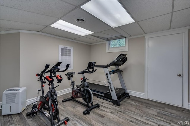 22036 Riverbend Dr W, Le Ray, NY 13601 - workout area featuring wood finished floors, ornamental molding, baseboards, visible vents, and a paneled ceiling