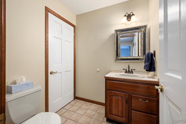 half bath featuring toilet, vanity, baseboards, and tile patterned flooring