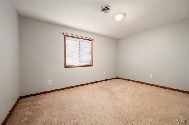 unfurnished room with light carpet, baseboards, and visible vents