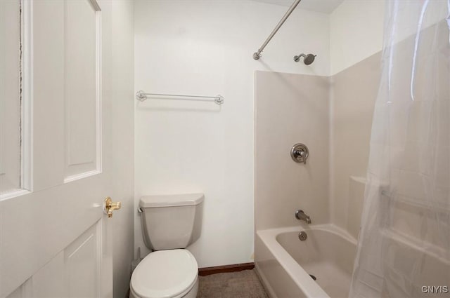 bathroom featuring baseboards, shower / tub combo, and toilet