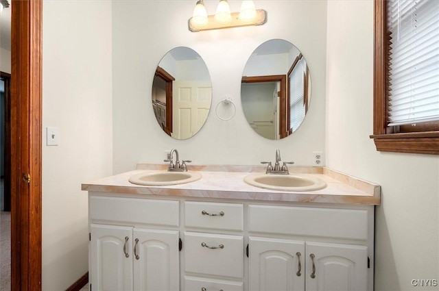 bathroom featuring double vanity and a sink