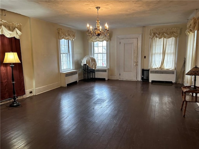 810 River Rd, Sanford, NY 13754 - unfurnished dining area with radiator, a chandelier, and wood-type flooring