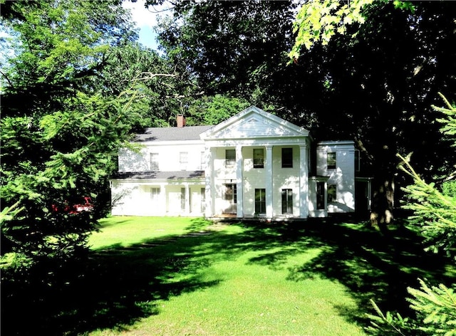 810 River Rd, Sanford, NY 13754 - neoclassical home with a front lawn and a chimney