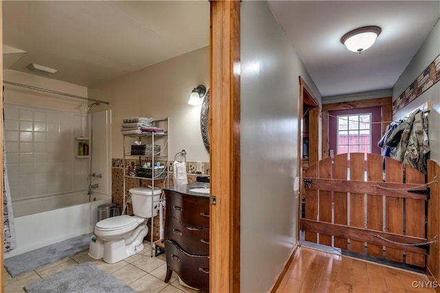 full bath featuring visible vents, toilet, vanity,  shower combination, and tile patterned flooring