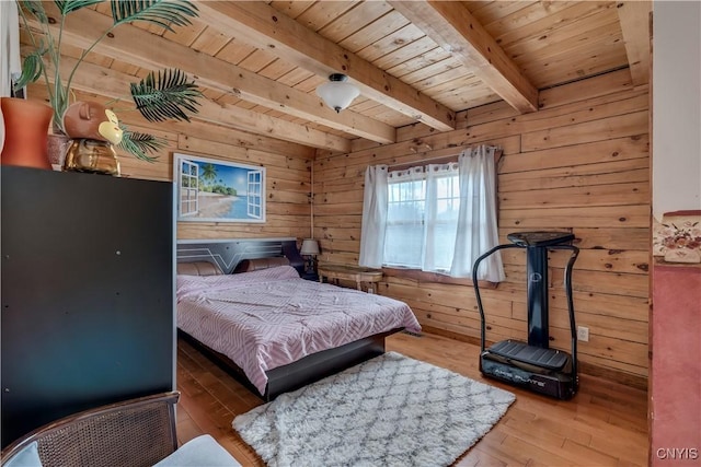 bedroom featuring beamed ceiling, wooden walls, wooden ceiling, and hardwood / wood-style flooring