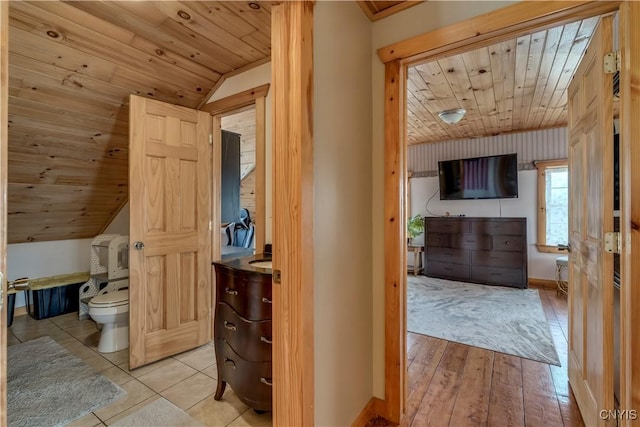 interior space featuring wooden ceiling, baseboards, lofted ceiling, and wood finished floors