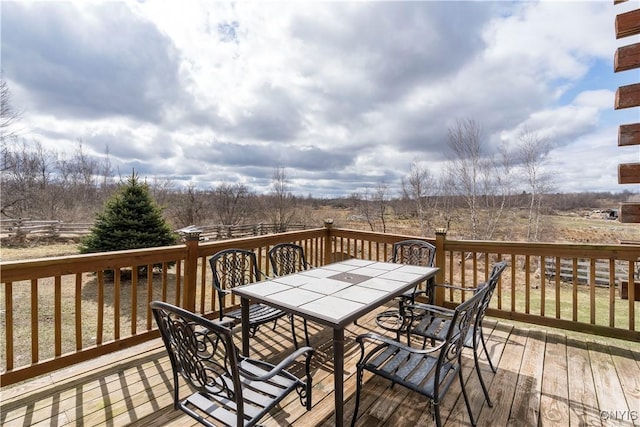 wooden terrace featuring outdoor dining area