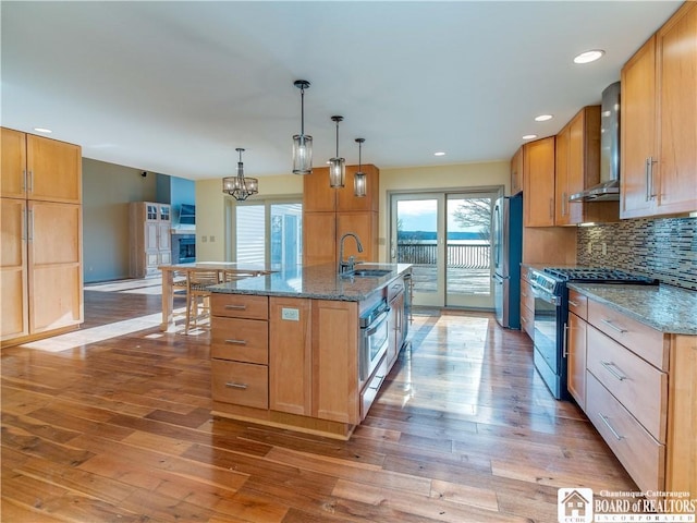 5464 Crestwood Rd, Ellery, NY 14712 - kitchen featuring backsplash, a sink, wall chimney exhaust hood, wood finished floors, and stainless steel appliances