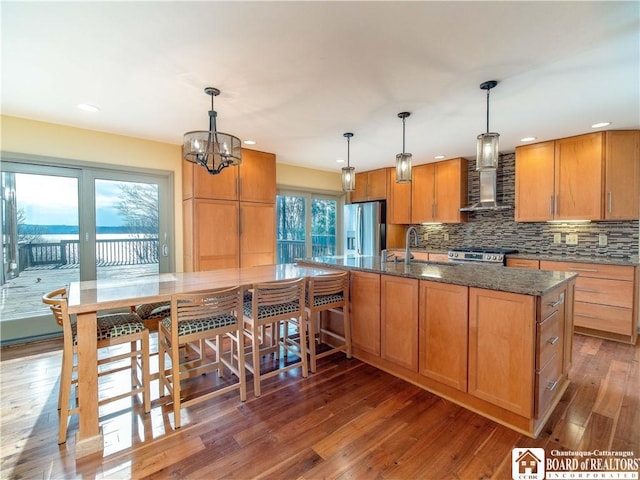 5464 Crestwood Rd, Ellery, NY 14712 - kitchen featuring stainless steel appliances, tasteful backsplash, a sink, wall chimney range hood, and wood-type flooring