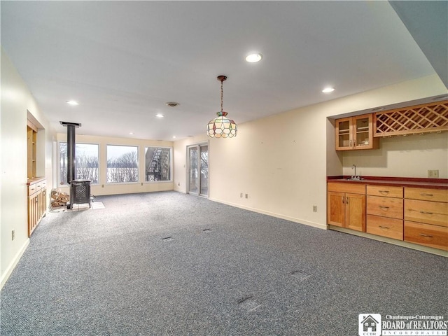 5464 Crestwood Rd, Ellery, NY 14712 - unfurnished living room featuring recessed lighting, wet bar, a sink, a wood stove, and dark colored carpet