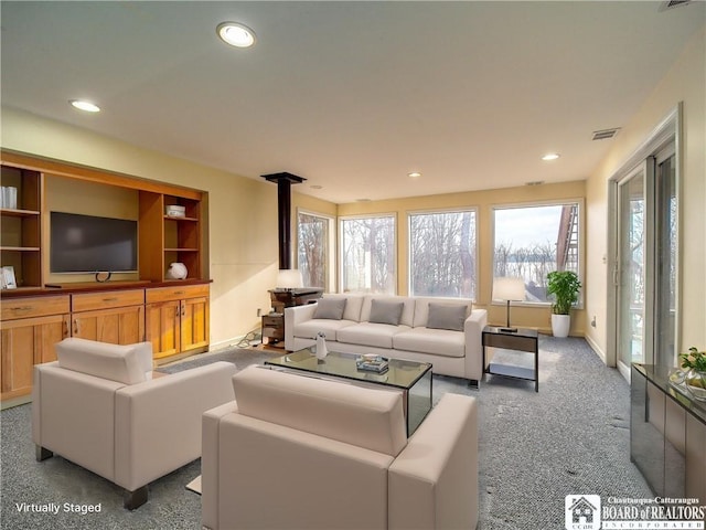 5464 Crestwood Rd, Ellery, NY 14712 - carpeted living area with baseboards, visible vents, a wood stove, and recessed lighting