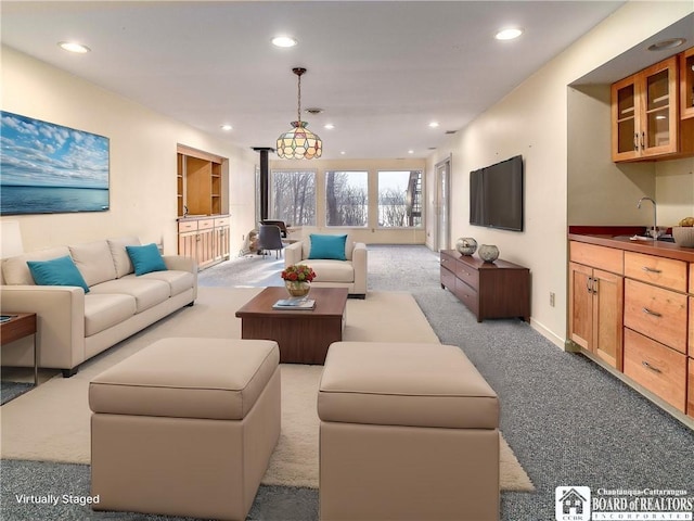 5464 Crestwood Rd, Ellery, NY 14712 - living room with carpet floors, baseboards, recessed lighting, and a wood stove