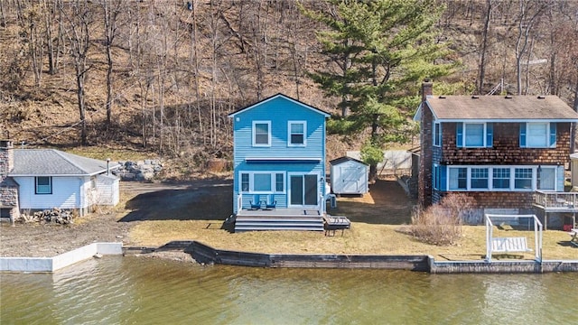 5170 Sunnyside Rd, Italy, NY 14507 - back of house with a water view, an outbuilding, and a storage unit