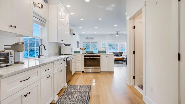 5170 Sunnyside Rd, Italy, NY 14507 - kitchen featuring a sink, white cabinetry, appliances with stainless steel finishes, light wood-style floors, and ceiling fan