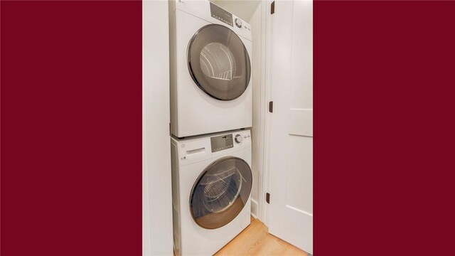 5170 Sunnyside Rd, Italy, NY 14507 - clothes washing area with stacked washing maching and dryer, laundry area, and wood finished floors