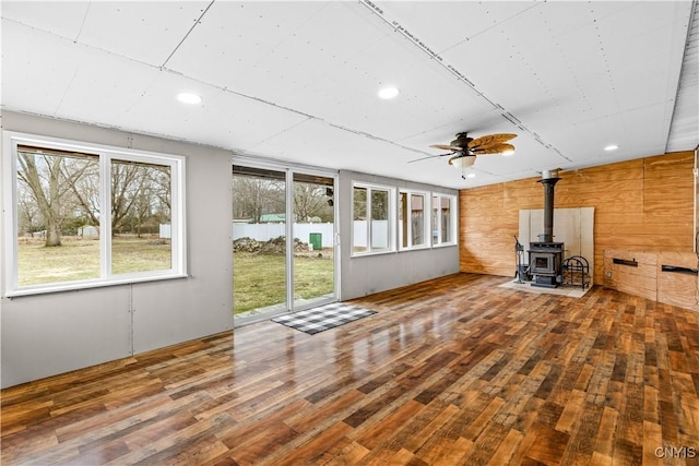 unfurnished sunroom featuring a wood stove