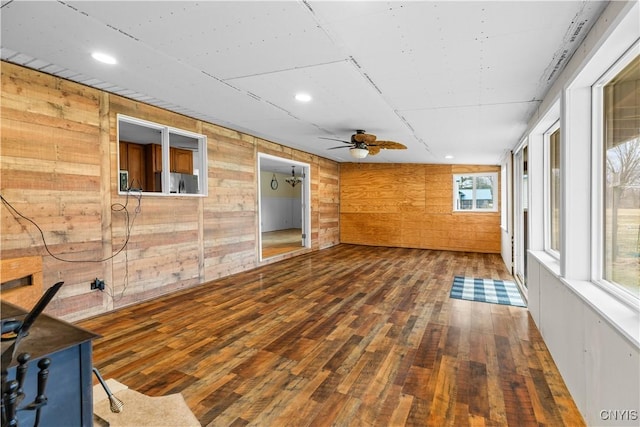 spare room featuring a ceiling fan, recessed lighting, wooden walls, and wood-type flooring
