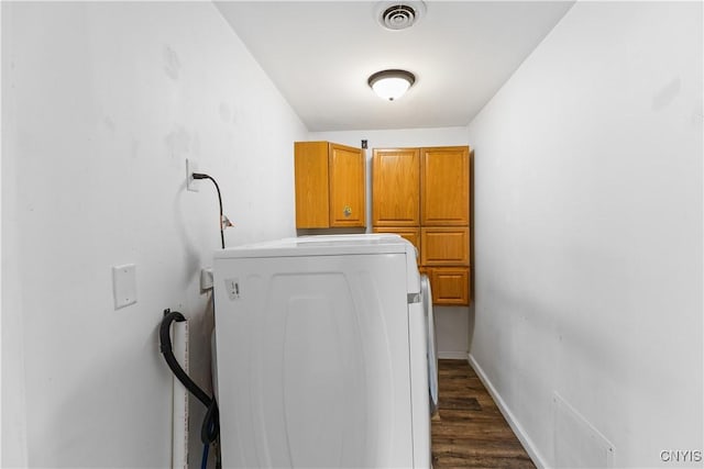laundry room featuring baseboards, dark wood-style floors, washer / dryer, visible vents, and cabinet space