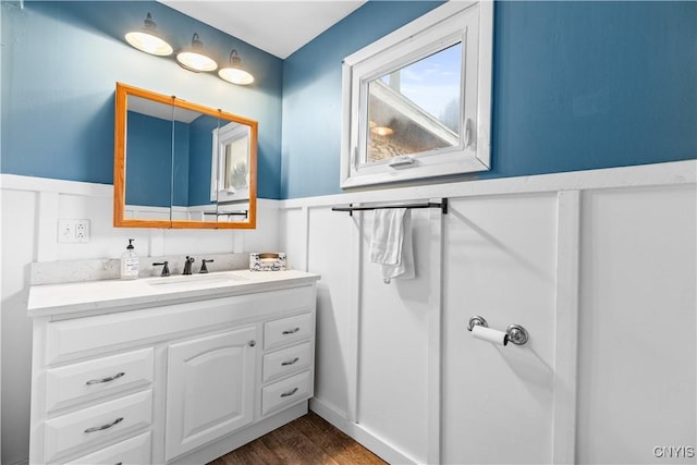 bathroom featuring wainscoting, wood finished floors, and vanity