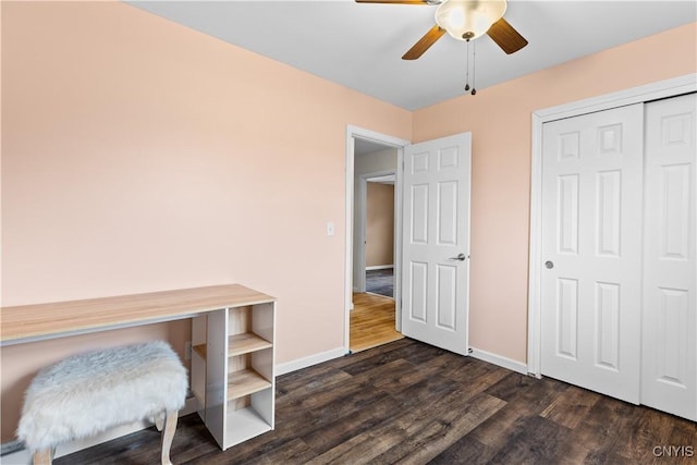 home office featuring a ceiling fan, dark wood-style floors, and baseboards