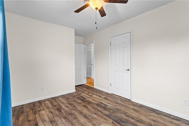 unfurnished bedroom featuring baseboards, wood finished floors, and ceiling fan