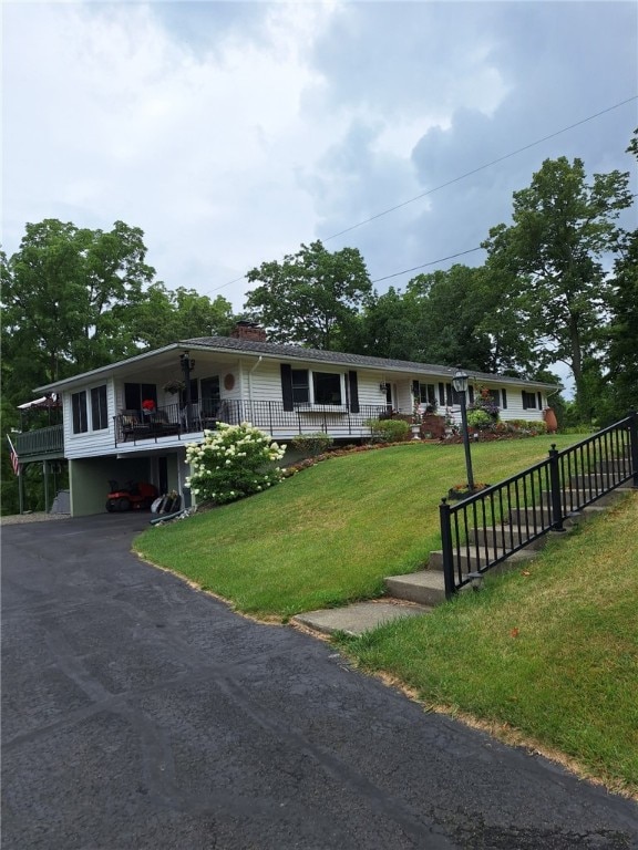 single story home with driveway, a front lawn, and a porch