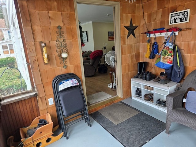interior space featuring crown molding and tile walls