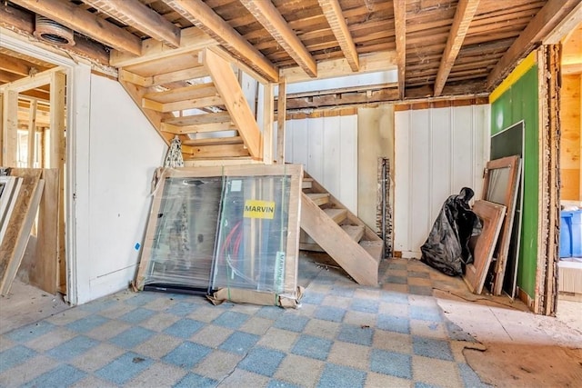 below grade area featuring stairs and carpet floors
