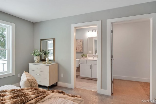 00 Beattie Ave, Lockport-Town, NY 14094 - bedroom featuring light carpet, baseboards, connected bathroom, and a sink