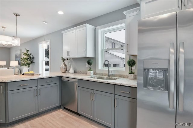 00 Beattie Ave, Lockport-Town, NY 14094 - kitchen with gray cabinetry, a sink, light stone counters, light wood finished floors, and appliances with stainless steel finishes