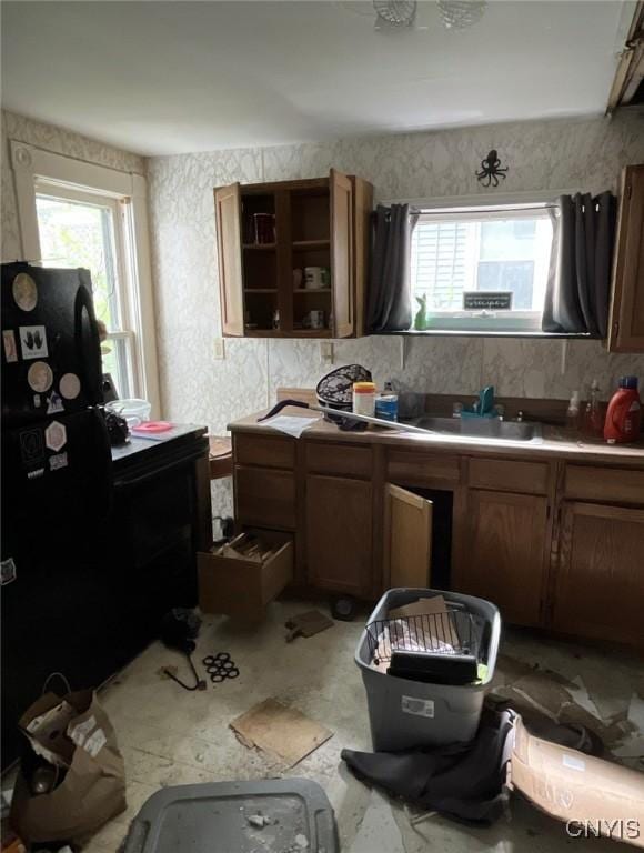 24 Spring St, German Flatts, NY 13357 - kitchen with healthy amount of natural light, brown cabinetry, and a sink